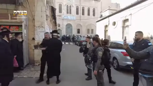 Video still: Israeli police confronting Haredi men on a street